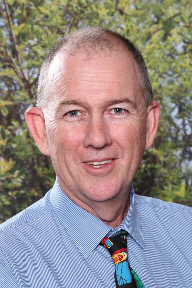 Principal Kingsley Ireland with foliage in the background
