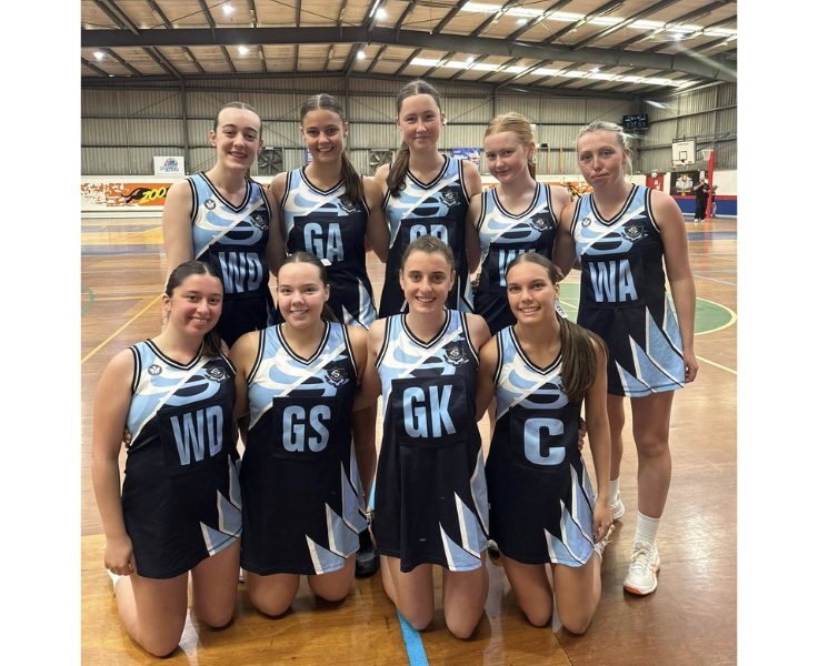 Girls netball team posing for a group photo after their win