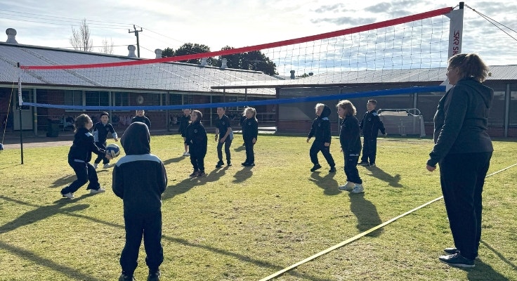 Primary students playing volleyball for the first time.