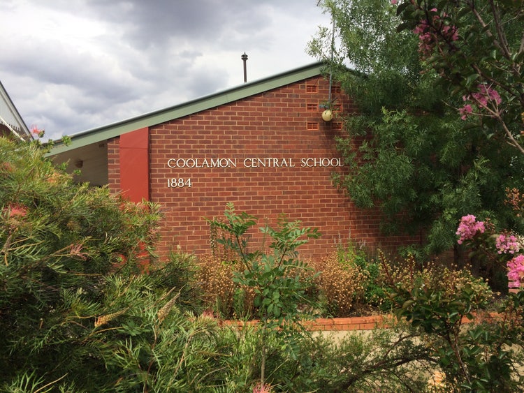 Photo of staff room building surrounded by foliage with the school name and year of establishment 1884 displayed